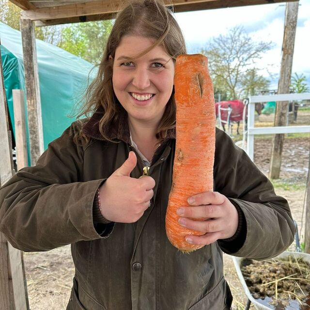 Emily mit einer sehr großen Möhre in der Hand